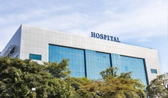 A large, modern hospital building, representing the healthcare industry which relies on dependable water storage tank solutions.