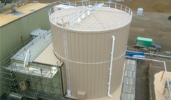 Insulated industrial storage tank installation for data center cooling systems and thermal energy storage infrastructure.